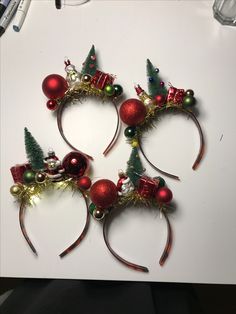 four headbands with christmas decorations on top of each other and trees in the middle