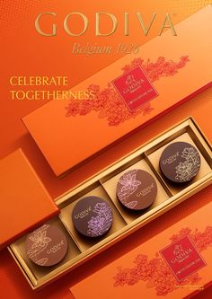 godiva chocolates are displayed in an orange box with gold lettering on the side