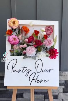 a sign with flowers on it that says, patty over her here and there is an easel next to the sign