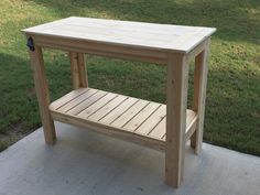 a wooden table sitting on top of a sidewalk