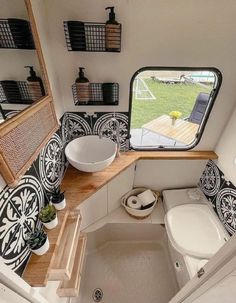 the inside of a tiny bathroom with sink, toilet and shower in it's stall