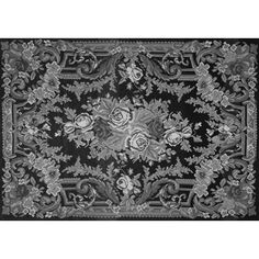 a black and white rug with flowers on it