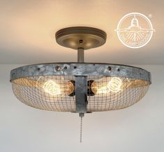 the light fixture is made out of metal wire and has two bulbs on each side