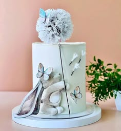 a white cake decorated with flowers and butterflies