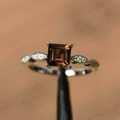 an engagement ring with a brown and white diamond