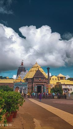 people are walking around in front of a large building with many pillars and domes on it