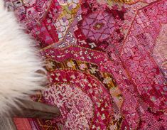 a close up of a pink rug with white fur on it