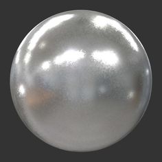 a shiny silver ball ornament on a black background