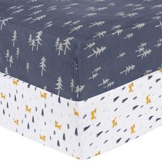 an image of a bed sheet with trees and animals printed on the bottom half of it