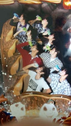 a group of people riding on top of a roller coaster