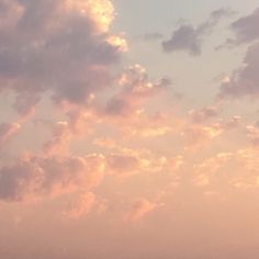 two airplanes flying in the sky at sunset