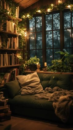 a living room filled with furniture and lots of plants in the window sill next to a bookshelf