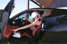 a woman sitting in the driver's seat of a car