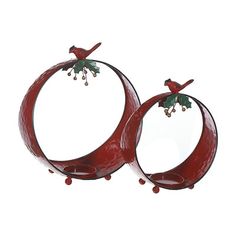 two red circular metal objects with birds on them