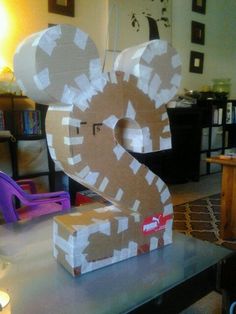 a sculpture made out of cardboard sitting on top of a table in a living room