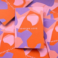 several orange and purple business cards with the words sending love written on them in different colors