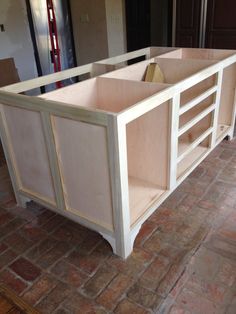 an unfinished kitchen cabinet in the process of being built