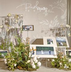 an assortment of flowers and pictures on display in front of a wall with the words pure studio