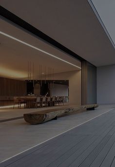 a large wooden bench sitting on top of a hard wood floor next to a building