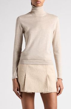 Tom Ford's tasteful elegance pervades this trim turtleneck sweater knit in Italy from silk-softened cashmere with finely ribbed trim. 23 1/2" length (size Medium) Turtleneck Long sleeves Ribbed cuffs and hem 70% cashmere, 30% silk Dry clean Made in Italy Designer Clothing Elegant Merino Wool Fine Knit Tops, Elegant Fine Knit Merino Wool Tops, Luxury Fine Knit Formal Sweater, Luxury Beige Sweater For Workwear, Luxury Beige Sweater For Work, Elegant Long Sleeve Merino Wool Top, Elegant Fitted Formal Sweater, Fitted Luxury Merino Wool Sweater, Luxury Fitted Merino Wool Sweater