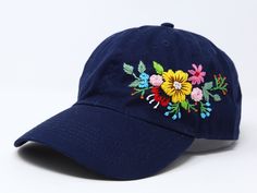 Flower is 100% hand embroidered on a 100% cotton wash baseball cap. Hat is one size fits all with adjustable back strap. Unique cap, one of a kind! I am also open for customization. If you want the item in different colors, please message me, it will take additional 2-3 days of handling time. Free first class shipping, upgradable priority mail service. 30 days return policy, feel confident at your purchase! Navy Hat For Spring (one Size Fits Most), Navy Hat For Spring, One Size Fits Most, Spring Navy Hat, Navy Spring Cap, Spring Navy Adjustable Hats, Navy Embroidered Baseball Cap, Navy Adjustable Baseball Cap For Spring, Adjustable Navy Embroidered Hat, Navy Embroidered Cap