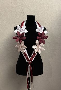 a black mannequin with red and white flowers on it