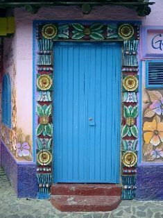 a blue door is painted on the side of a building