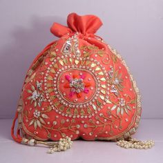 "Beautiful Golden Ribbon Cut Work Thread Embroidered Beaded Indian Traditional Wedding Potli Bags Bridemaids Gift Handbag Material: Organza, Golden Ribbon, Golden Tread, Golden Sequins, Motifs Package Contents: As per quantity purchased Size: 10\" x 8\" Designed with the heart, this beautiful Potli or batawa bag are eye catchy and made of premium material. Key Features: Embroidery art work This potli is good match with both Indian and western outfits and are superb for wedding and festive partie Embellished Pouch Bag For Reception, Embroidered Pouch For Reception, Beaded Festival Clutch Bag, Beaded Clutch Bags For Festivals, Festival Beaded Clutch Bag, Pink Zari Work Bag For Reception, Red Embroidered Shoulder Bag For Wedding, Festive Pink Embellished Bag, Festive Pink Embellished Bags