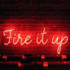 a red neon sign that says fire it up