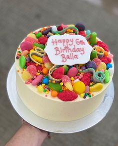 a birthday cake that has been decorated with candy and confetti on the top