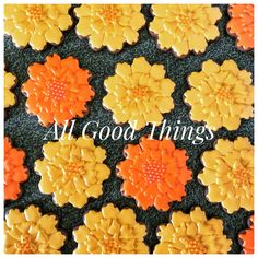 orange and yellow flowers are arranged on a black background with the words all good things