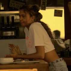 a woman standing at a counter in a restaurant