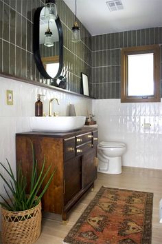 a bathroom with a sink, toilet and rug