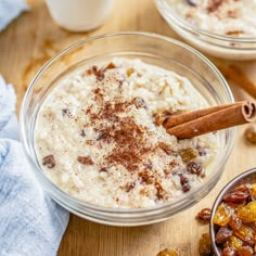 three bowls filled with oatmeal and nuts on top of a wooden table