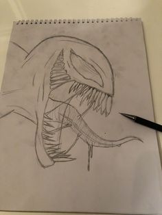 a pencil drawing of a dinosaur with its mouth open