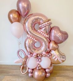 the balloon bouquet is made up of balloons and heliums that spell out the number five