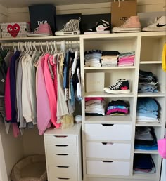 an organized closet with clothes and shoes