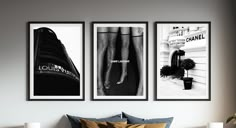 three black and white pictures hang above a bed