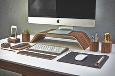 an image of a desktop computer on a desk with mouse, keyboard and cell phone