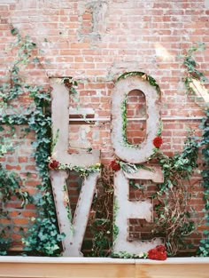 an old love sign is covered in ivy