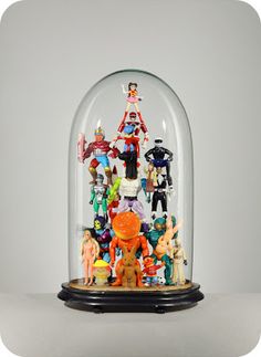 a glass dome filled with lots of toy figurines