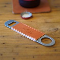 a bottle opener sitting on top of a wooden table