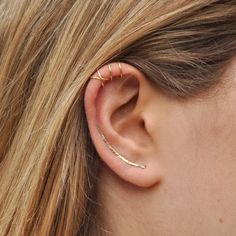 a close up of a person with ear piercings