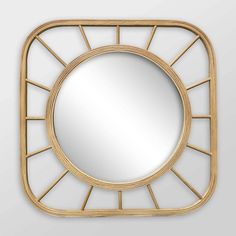 a mirror that is sitting on top of a white wall and it has gold trim around the edges