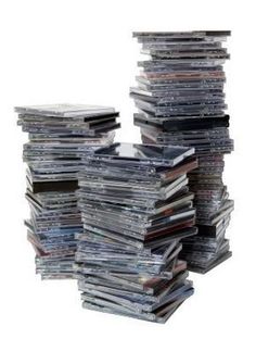 a stack of cds sitting on top of each other in front of a white background