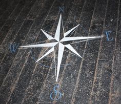 a compass on the ground with blue numbers