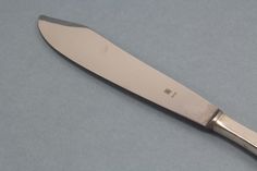 a large knife on a gray surface