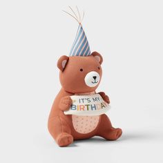 a brown teddy bear holding a sign with it's my birthday written on it