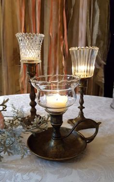 two candles are sitting on top of a table