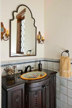 a bathroom with a sink and mirror in it